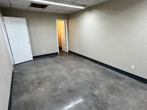 Bay City apartment for rent - A room with a concrete floor and a white door.