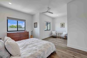 Twin Falls house for rent - A bedroom with a bed, a guitar, a chair, and a window.
