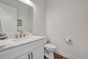 Twin Falls house for rent - A white toilet sits next to a sink in a bathroom.