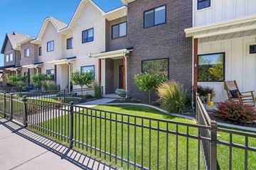 Twin Falls house for rent - A row of houses with a black fence in front.