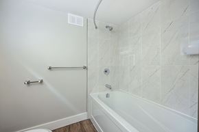 London apartment for rent - A white bathroom with a tub and shower.