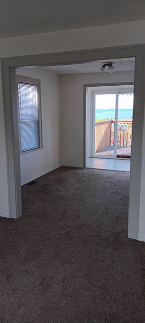 Everett apartment for rent - A room with a carpeted floor and a window overlooking a deck.