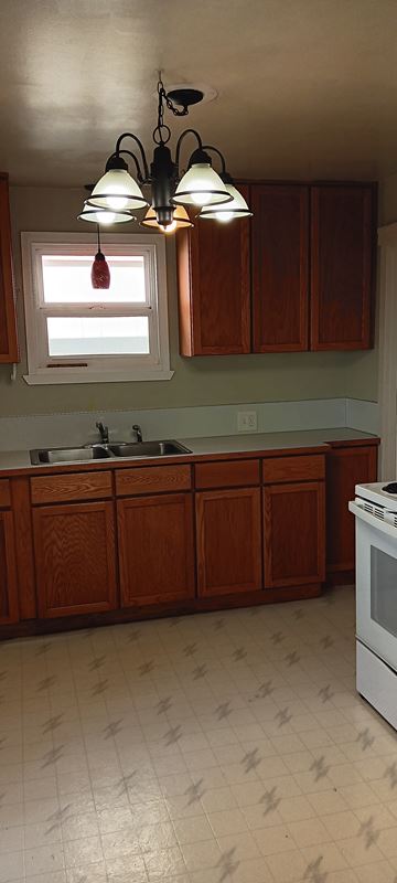 Everett apartment for rent - A kitchen with wooden cabinets and a white stove.