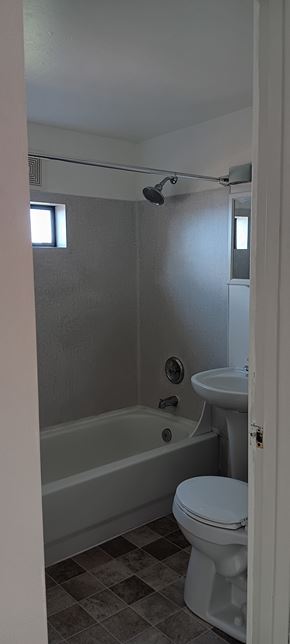 Everett apartment for rent - A white toilet sits next to a bathtub in a bathroom.