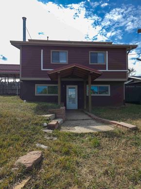 La Veta house for rent - A house with a red roof and a white door.