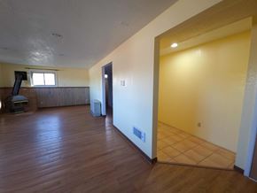 La Veta house for rent - A room with wooden floors and a window.