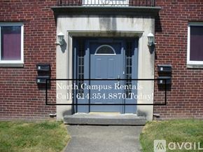 Columbus apartment for rent - A grey door with a window on the wall.