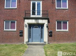 Columbus apartment for rent - A red brick building with a blue door and windows.