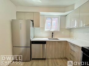 Chicago apartment for rent - A kitchen with a stove, oven, microwave, and refrigerator.