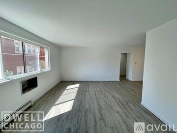 Chicago apartment for rent - A modern living room with a black couch and a television.