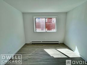 Chicago apartment for rent - A modern dining room with a white table and chairs.