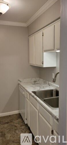 Nashville condo for rent - A kitchen with white cabinets and a marble countertop.