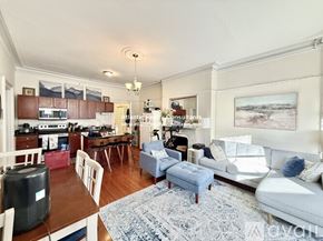 Boston apartment for rent - A kitchen with a black countertop and a white refrigerator.