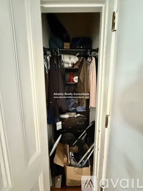 Boston apartment for rent - A bedroom with a bed, dresser, and lamp.