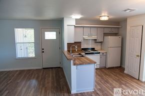Austin apartment for rent - A kitchen with white appliances and wooden countertops.