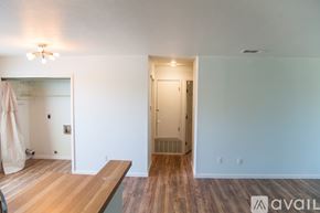 Austin apartment for rent - A room with a wooden floor and a door leading to a bathroom.