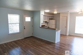 Austin apartment for rent - A kitchen area with a refrigerator, sink, and cabinets.