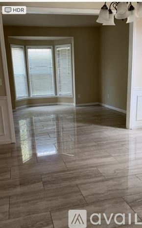 Hiram house for rent - A spacious room with tiled flooring and sliding glass doors.
