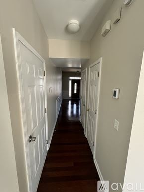 Hiram house for rent - A long hallway with white doors and a light on the ceiling.