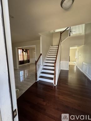 Hiram house for rent - A wooden staircase with white railings leads to a second floor.