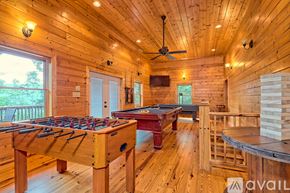 Clayton house for rent - A foosball table is in the middle of a room with a pool table and a TV.