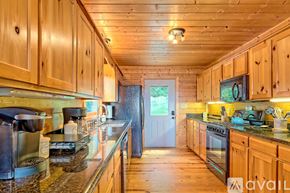 Clayton house for rent - A kitchen with wooden cabinets and granite countertops.