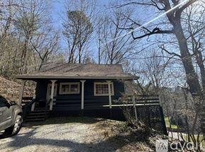 Dillard house for rent - A small house with a porch and a car parked in front.