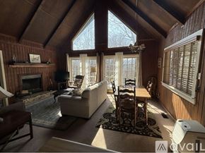 Dillard house for rent - A cozy living room with a fireplace and a large window.