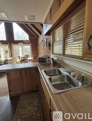Dillard house for rent - A kitchen with wooden cabinets and a sink.