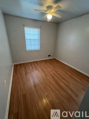 Manassas apartment for rent - A room with wooden flooring and a ceiling fan.