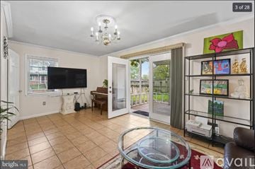 Manassas apartment for rent - A living room with a glass coffee table and a flat screen TV.