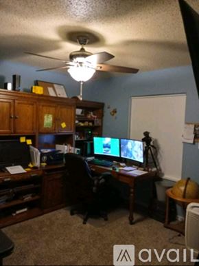 Brooksville apartment for rent - A room with a desk, computer, and a fan.