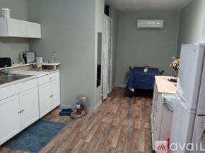 Brooksville apartment for rent - A kitchen with white cabinets and a blue rug on the floor.