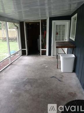 Brooksville apartment for rent - A patio with a white trash can and a table.