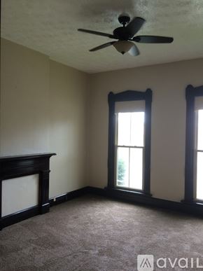 Dayton townhouse for rent - A room with a ceiling fan and two windows.