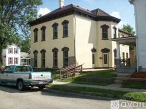 Dayton townhouse for rent - A white truck is parked in front of a tan building.