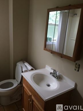 Dayton townhouse for rent - A bathroom with a toilet, sink and mirror.