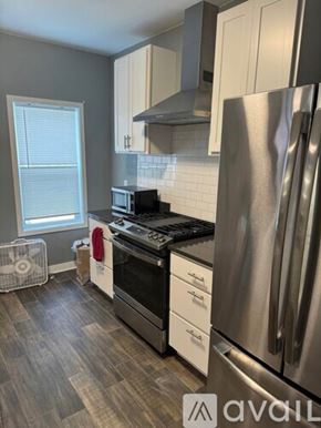 Madison apartment for rent - A kitchen with a stainless steel refrigerator, oven, and microwave.