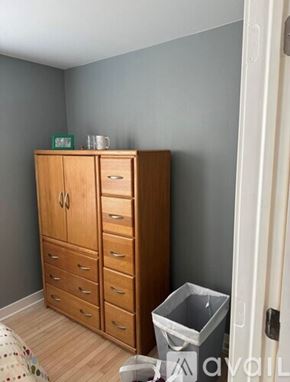Madison apartment for rent - A wooden cabinet with drawers and a green sign on top.