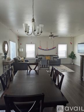 Eagle Mountain house for rent - A dining room with a long table and chairs.