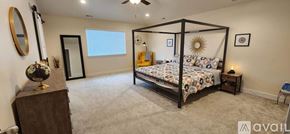 Eagle Mountain house for rent - A bedroom with a four poster bed and a dresser.