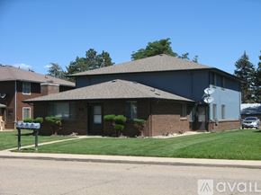 Longmont apartment for rent - A house with a grey roof and a mailbox in front.
