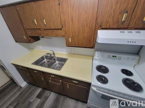 Sparta apartment for rent - A kitchen with wooden cabinets and a white stove top oven.