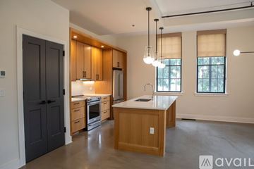 Northampton apartment for rent - A modern kitchen with a large island and pendant lights.