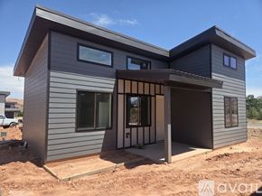 Moab townhouse for rent - A modern house under construction with a grey exterior and a large entrance area.