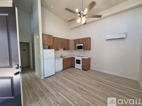 Moab townhouse for rent - A kitchen with white appliances and wooden cabinets.