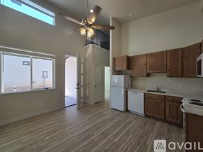 Moab townhouse for rent - A kitchen with wooden floors and a white fridge.