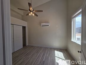 Moab townhouse for rent - A room with a ceiling fan and a window.