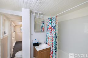 St. Petersburg house for rent - A small bathroom with a toilet, sink, and a mirror.