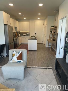 Aurora apartment for rent - A modern kitchen with a white chair and a white table.